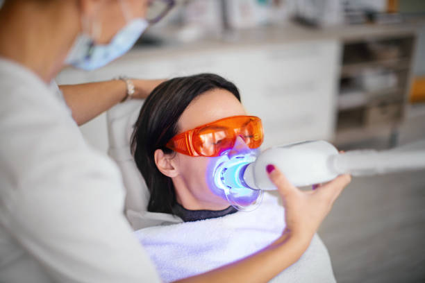 a woman undergoing teeth whitening treatment