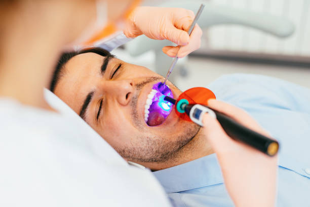 image of a man during a dental treatment of cavities